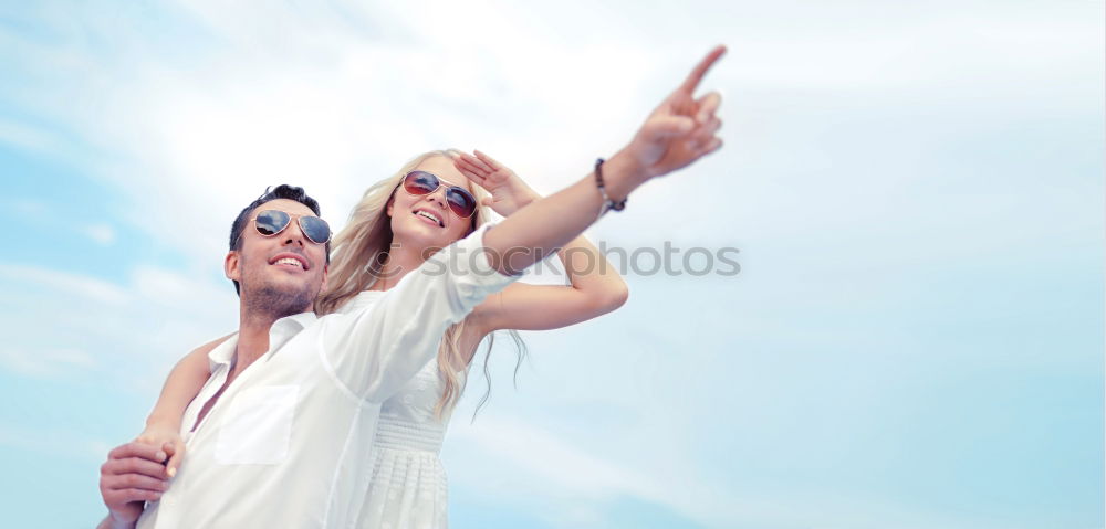 Happy family standing on the beach at the day time. People having fun outdoors. Concept of summer vacation and friendly family.