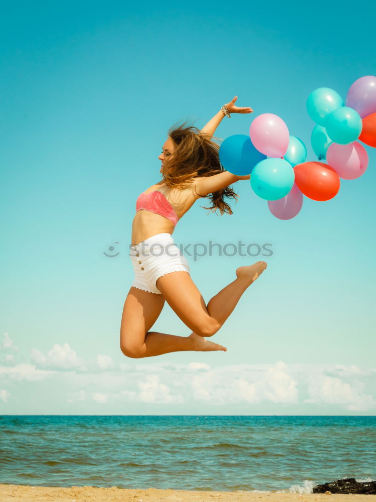 Similar – Father and daughter with balloons playing on the beach