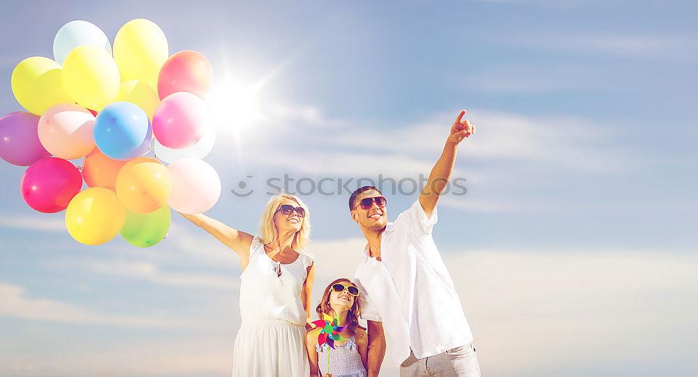 Similar – Father and daughter with balloons playing on the beach at the day time. Concept of friendly family.