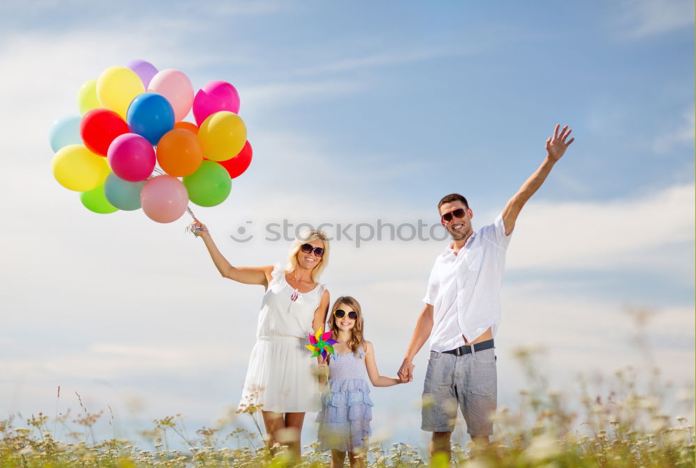 Similar – Father and daughter with balloons playing on the beach