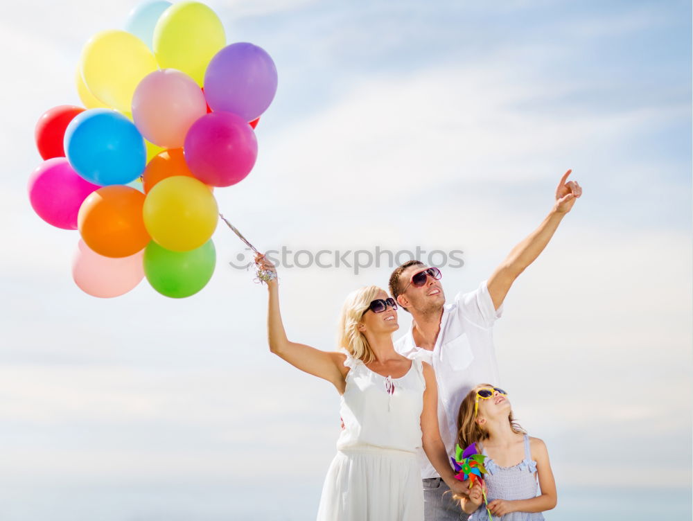 Similar – Father and daughter with balloons playing on the beach at the day time. Concept of friendly family.