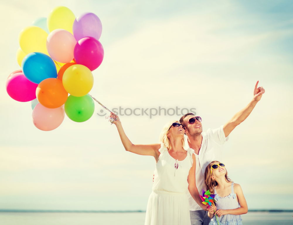 Similar – Father and daughter with balloons playing on the beach at the day time. Concept of friendly family.