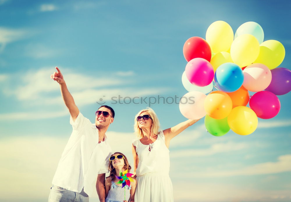 Similar – Father and daughter with balloons playing on the beach at the day time. Concept of friendly family.