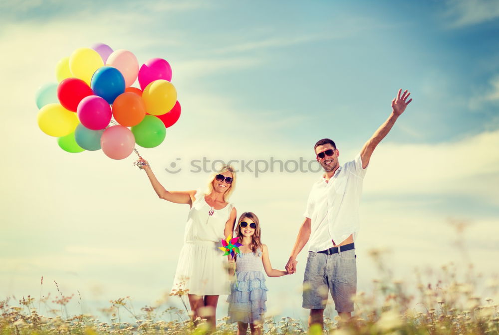 Similar – Father and daughter with balloons playing on the beach at the day time. Concept of friendly family.