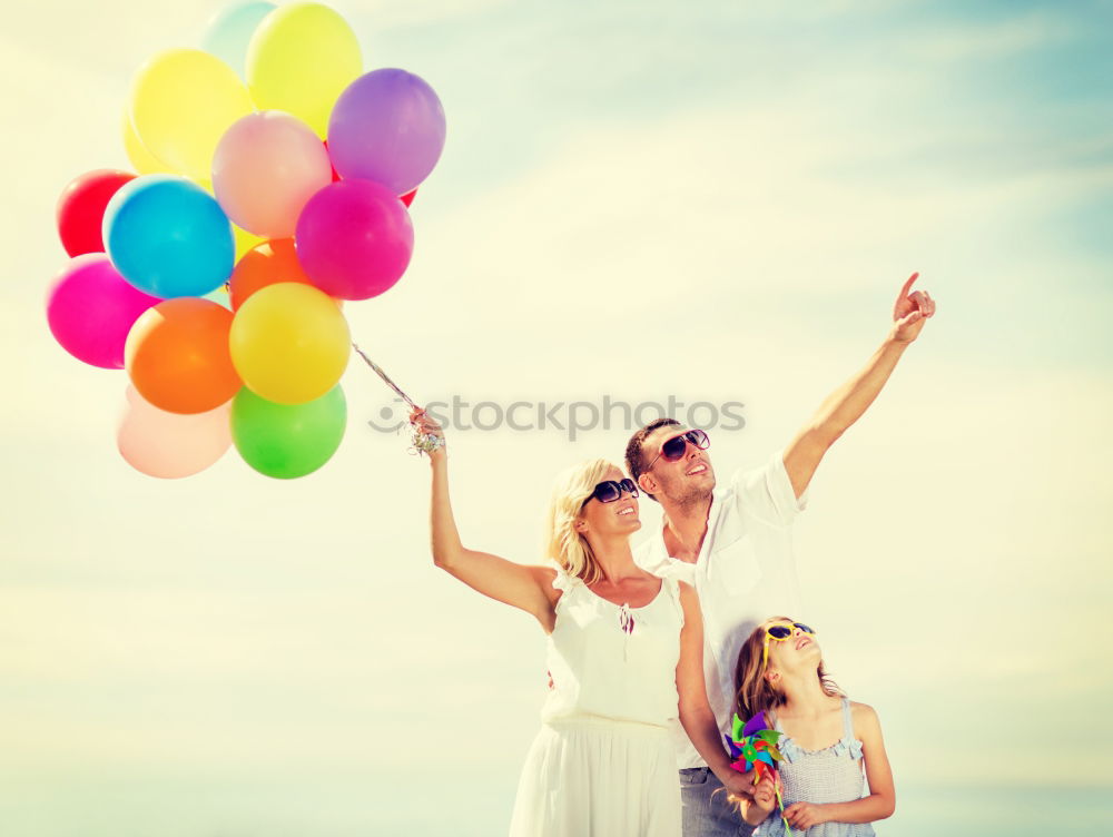 Similar – Father and daughter with balloons playing on the beach at the day time. Concept of friendly family.