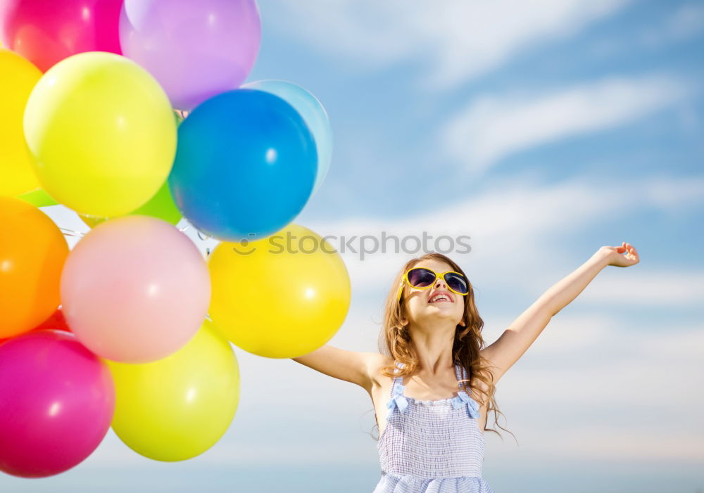 Similar – Young happy woman holding a heart shaped balloon