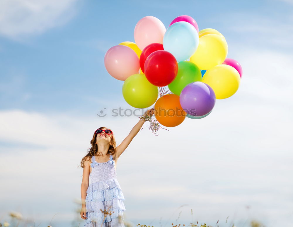 Similar – young woman with balloon on the mountain at a city