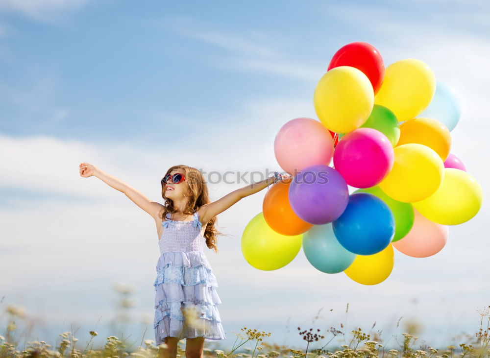 Similar – Young happy woman holding a heart shaped balloon