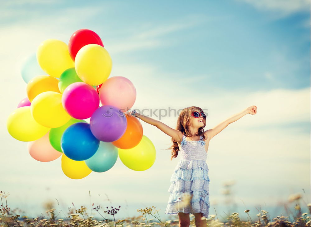 Similar – young woman with balloon on the mountain at a city