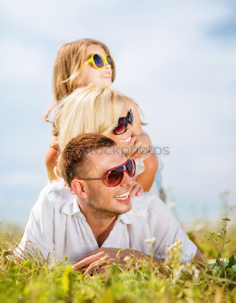 Similar – Image, Stock Photo Father and son relaxing near the house at the day time. They sitting near are the colorful wall. Concept of friendly family.