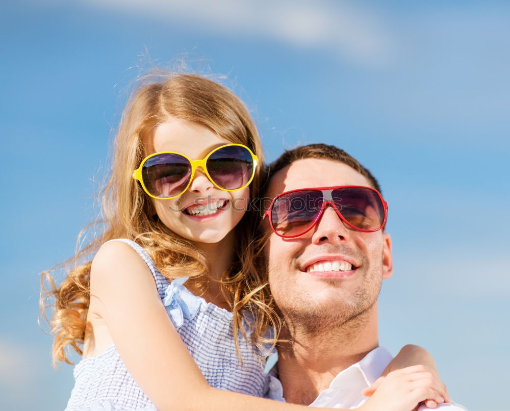 Similar – Father and son relaxing near the house at the day time. They sitting near are the colorful wall. Concept of friendly family.