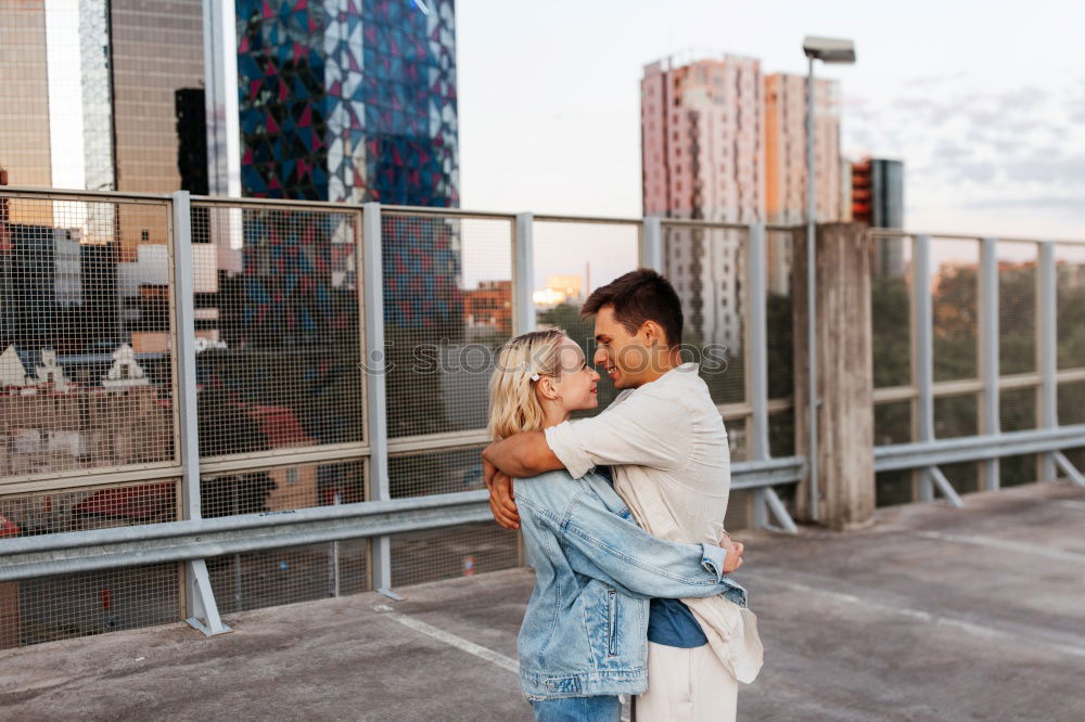 Similar – Couple embracing on evening street