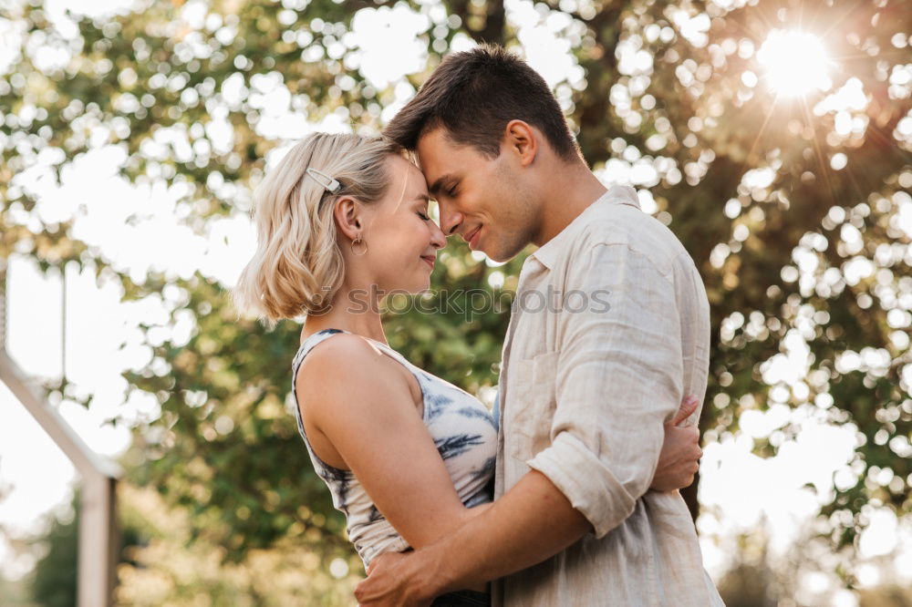 Similar – Image, Stock Photo Blonde woman and bearded man embracing and smiling together with a van in the background at sunset.