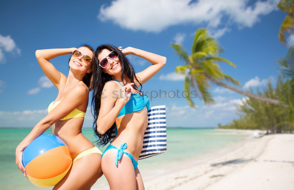 Similar – Zwei Frauen im Bikini, die auf einem tropischen Strandsand sitzen.