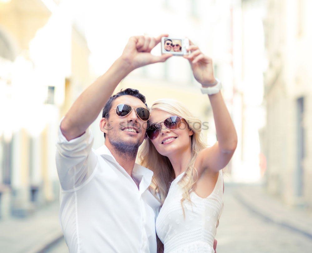 Similar – Happy young man and woman in fashionable sunglasses taking cellphone selfie on background of defocused blue sea. Vacation photos