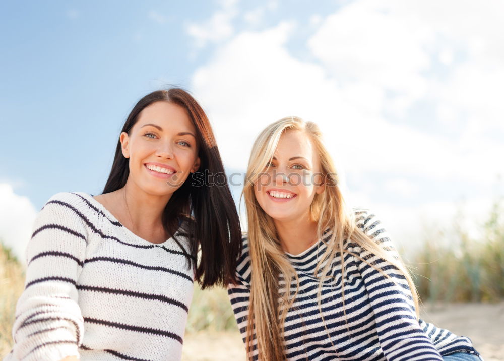 Similar – Two happy young women friends hugging in the street