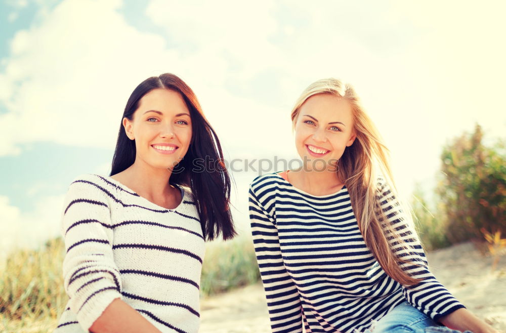 Similar – Two happy young women friends hugging in the street