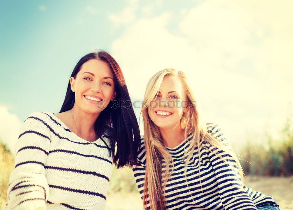 Similar – Two happy young women friends hugging in the street