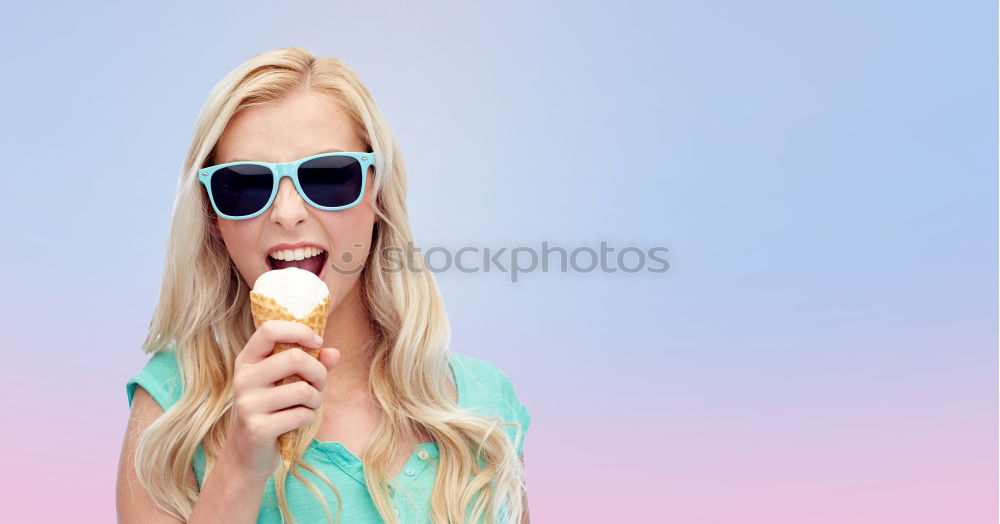 Young woman with pink hair is licking lollipops