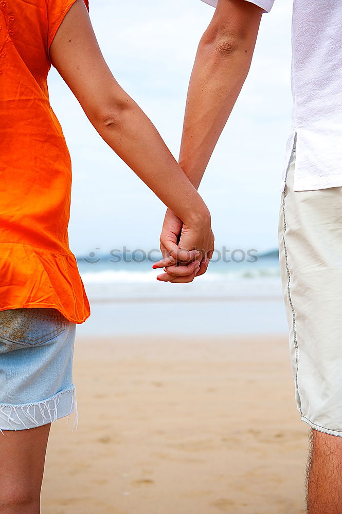 Similar – Closeup of couple holding hands