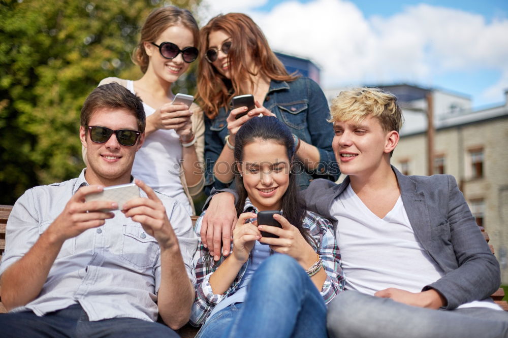 Similar – Multi-ethnic group of young people using smartphone