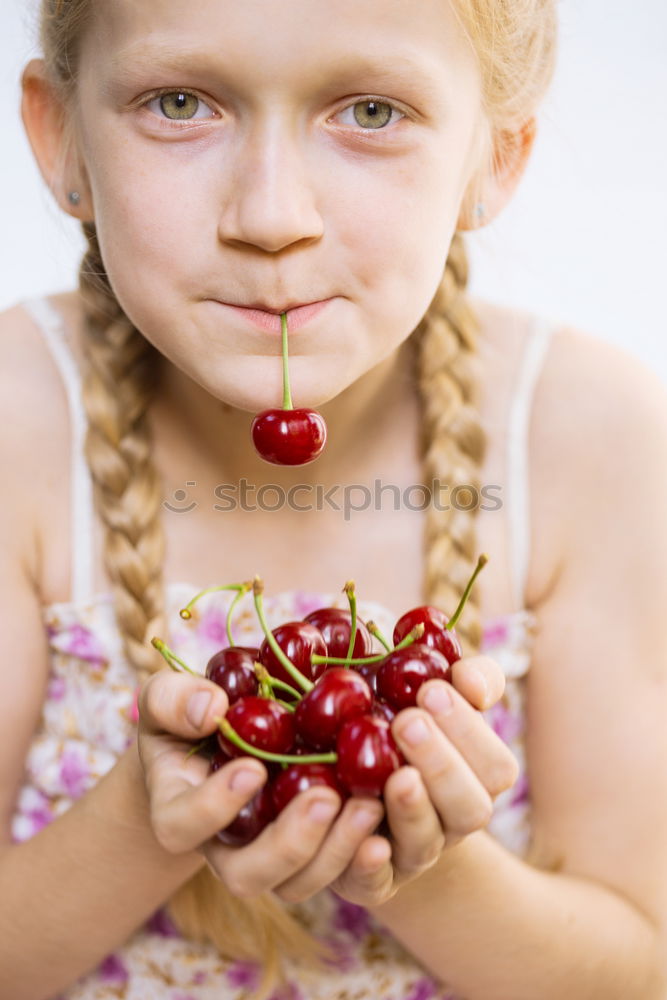 Similar – Child nibbles raspberries from his fingers