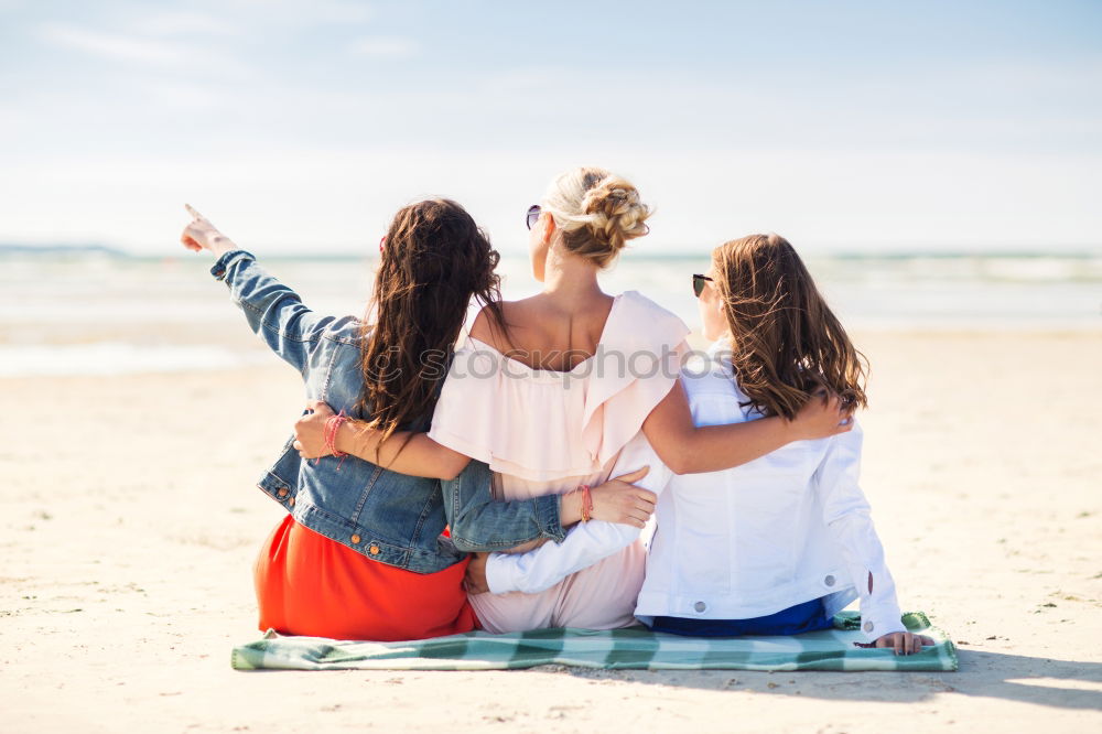 Group of best friends cheerful on the beach in sunset