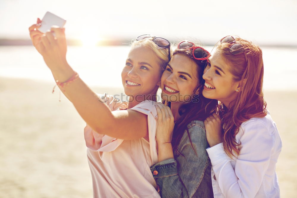 Similar – Beautiful women taking a selfie portrait in park.