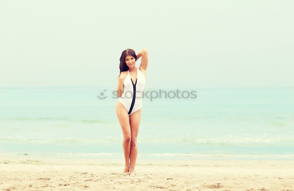 Similar – young nude girl with a hat walks on an empty beach near the sea surf against the blue sky with clouds in summer