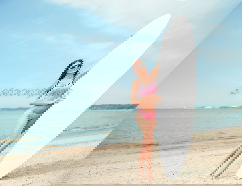 Similar – Image, Stock Photo Beautiful Surfer Girl standing on the Beach
