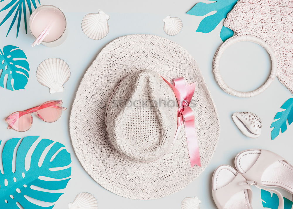 Summer woman accessories with shells and tropical leaves on pastel color background, top view. Straw hat, sunglasses, sandals and handbag. Holiday vacation. Female fashion outfit