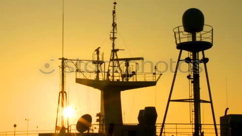 Similar – Truck cranes on rails in the orange evening sky