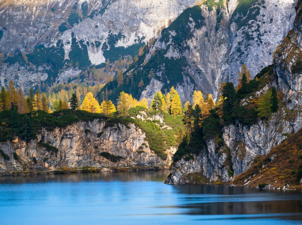 Mountain hut at Oeschinensee with intensive blue reflection