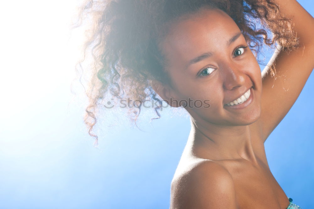 Similar – Black woman with afro hairstyle smiling in urban park.