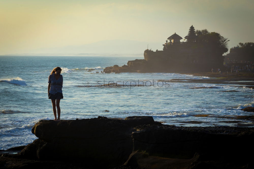 Similar – Man sitting on fence in rocky coast