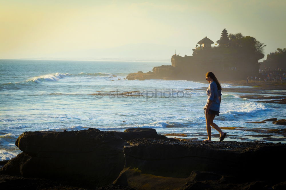 Similar – Man sitting on fence in rocky coast