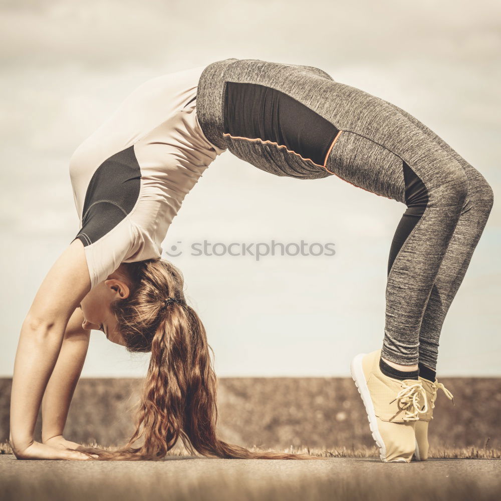 Image, Stock Photo Young caucasian woman doing yoga on road in sunset