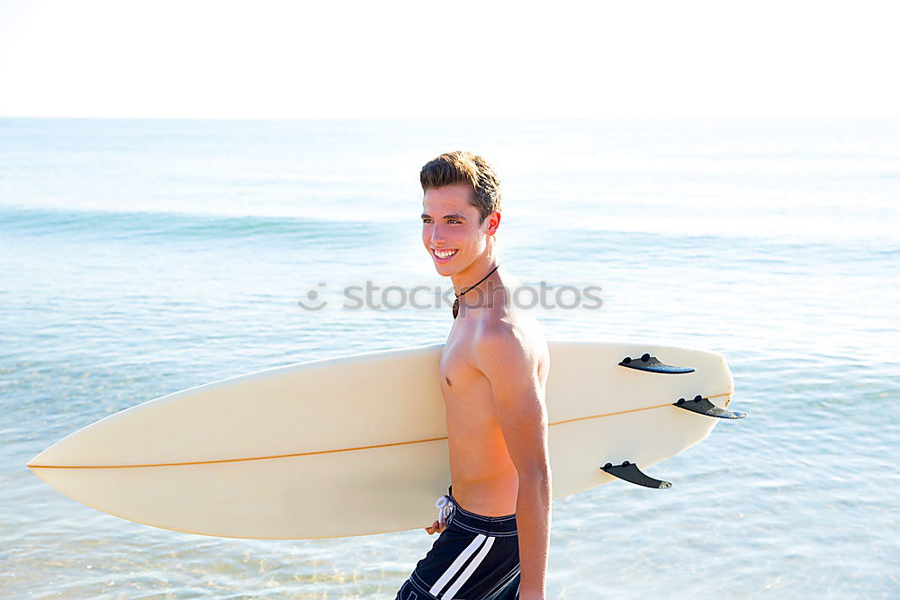 Similar – Man with tattoos holding skateboard at shore. Back view.