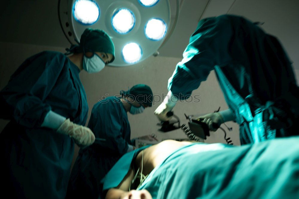 Similar – Image, Stock Photo Team of Surgeons Operating.