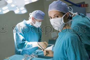 Similar – Image, Stock Photo Team of Surgeons Operating.