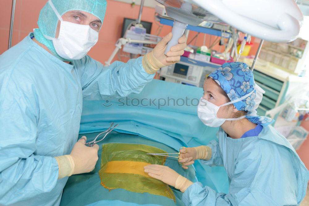 Similar – Image, Stock Photo Team of Surgeons Operating.