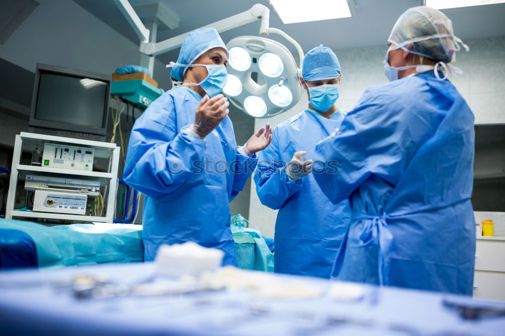 Similar – Image, Stock Photo Team of Surgeons Operating.