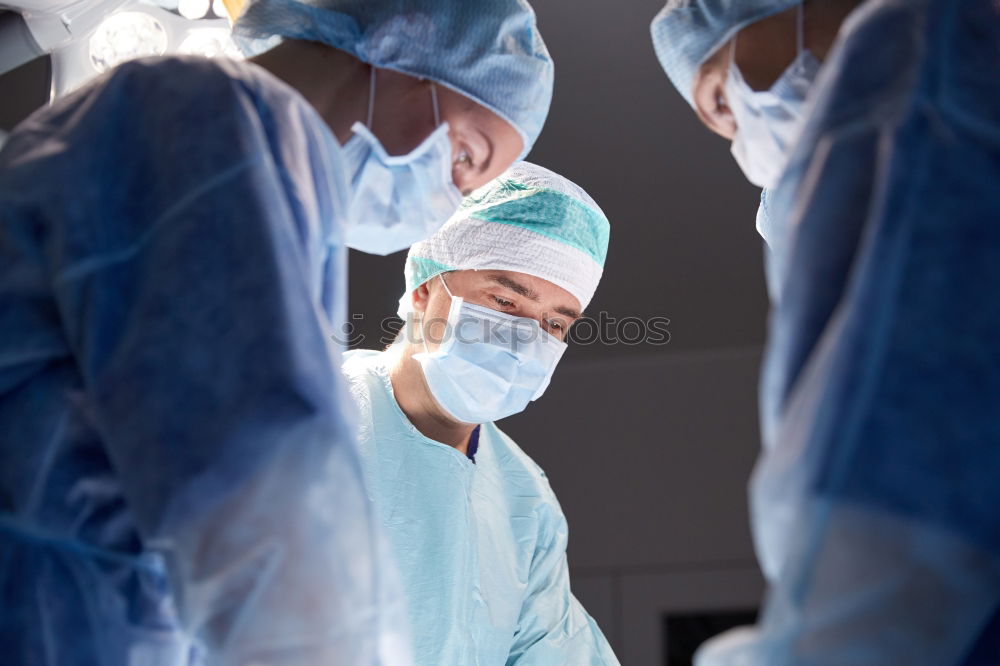 Similar – Image, Stock Photo Team of Surgeons Operating.