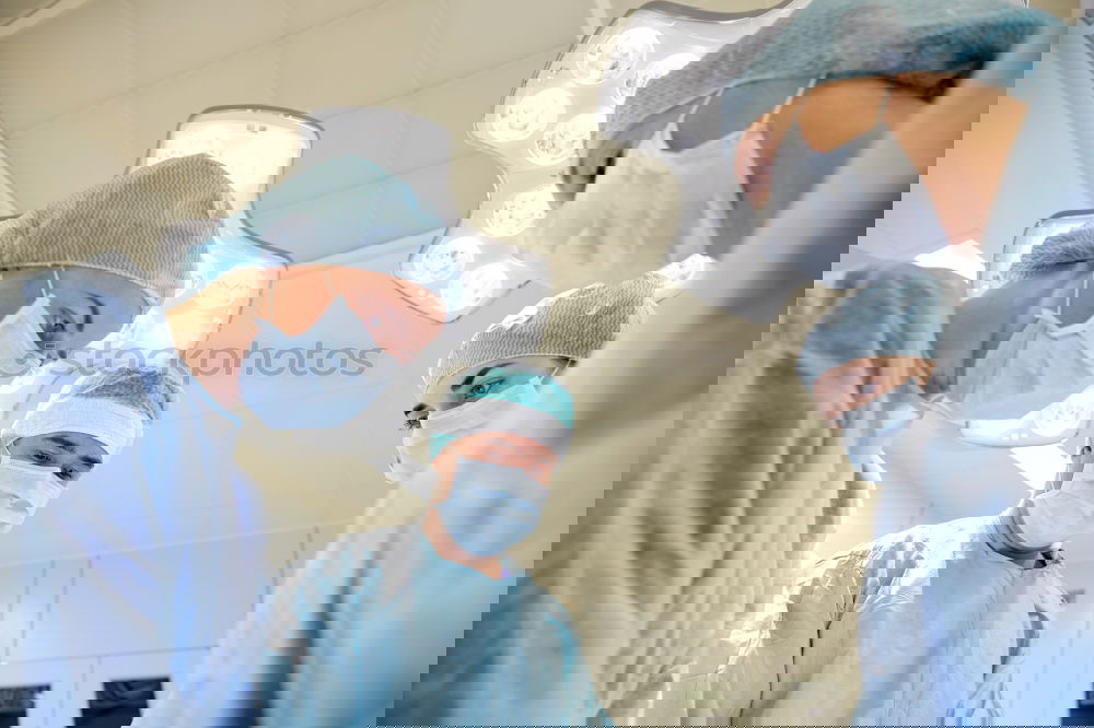 Similar – Image, Stock Photo Team of Surgeons Operating.