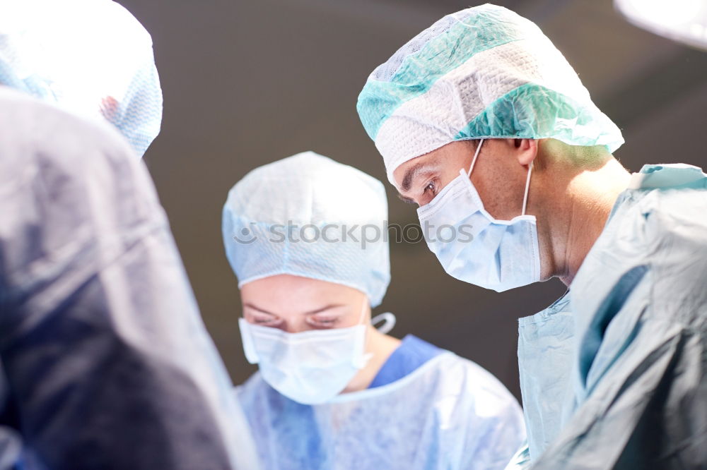 Similar – Image, Stock Photo Team of Surgeons Operating.