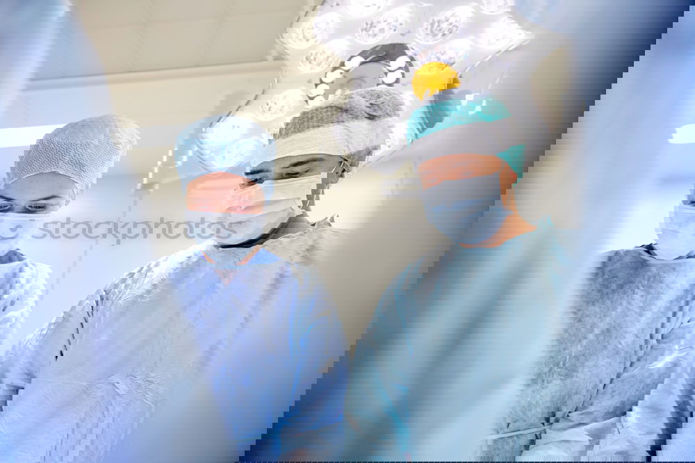 Similar – Image, Stock Photo Team of Surgeons Operating.