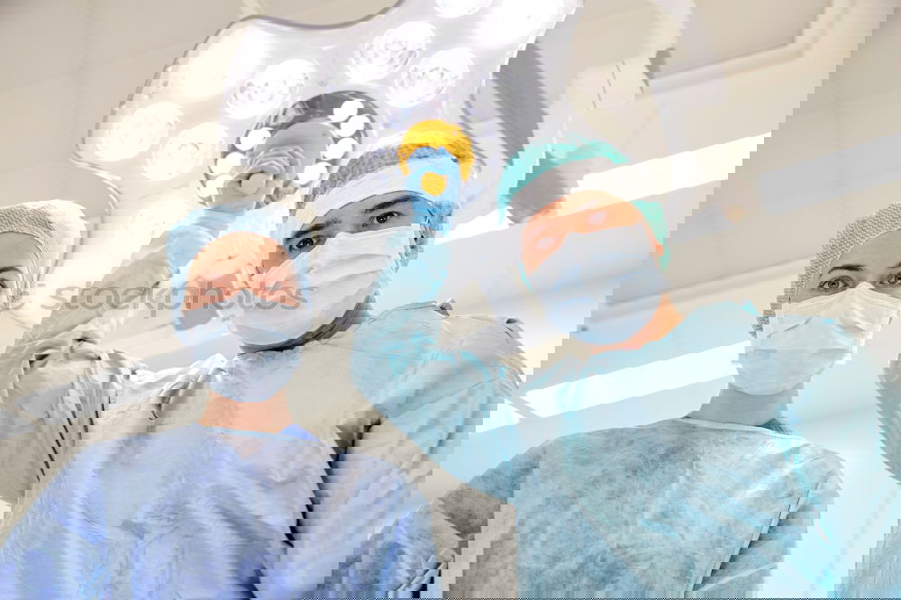 Similar – Image, Stock Photo Team of Surgeons Operating.