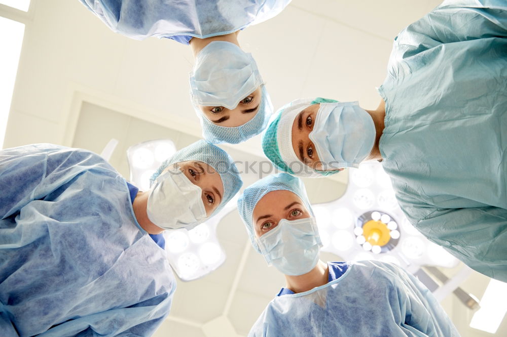 Similar – Image, Stock Photo Team of Surgeons Operating.