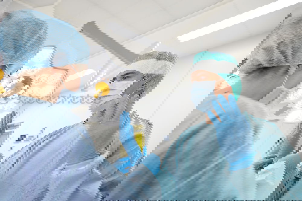 Similar – Image, Stock Photo Team of Surgeons Operating.