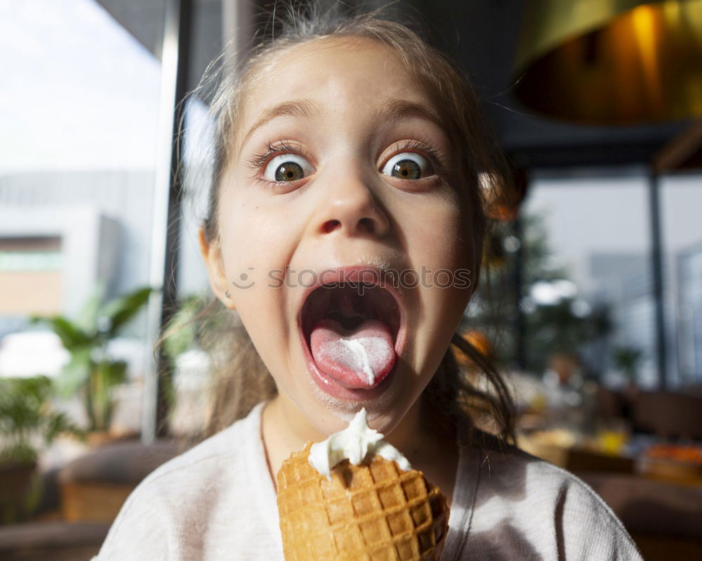 Similar – Little boy in a cafe during lunch. Hungry kid eating sausage from his sandwich